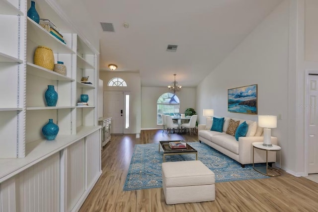 6332 35th Avenue Cir E, Palmetto, FL 34221 - living area featuring a chandelier, wood finished floors, baseboards, and vaulted ceiling