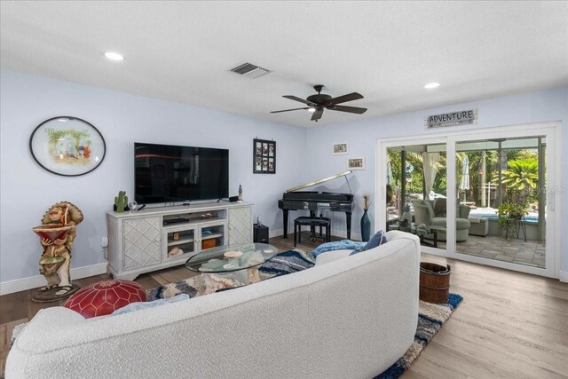 living area with wood finished floors, baseboards, a ceiling fan, and recessed lighting