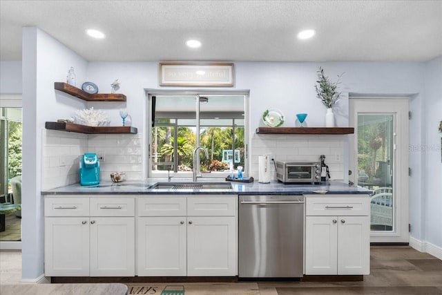 kitchen featuring dishwasher, open shelves, a sink, backsplash, and recessed lighting