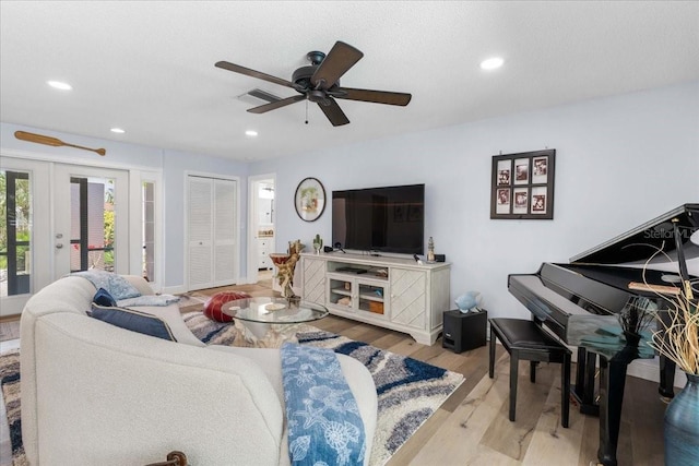 living area with ceiling fan, french doors, wood finished floors, and recessed lighting
