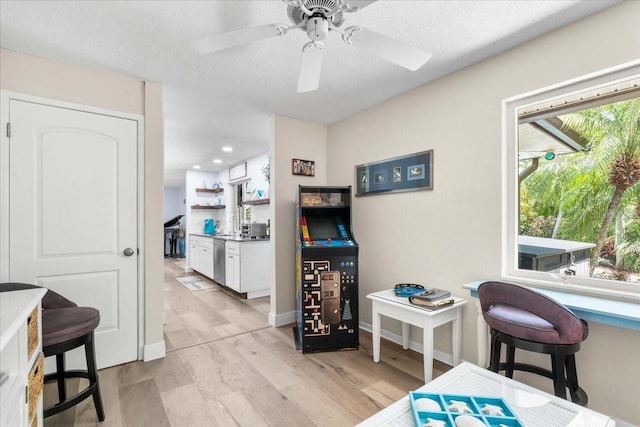 dining space with light wood finished floors, a ceiling fan, recessed lighting, and baseboards