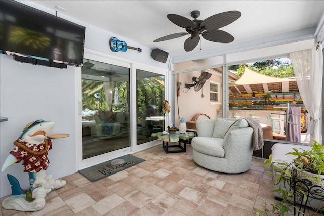 sunroom / solarium with a ceiling fan and outdoor lounge area