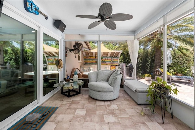 sunroom / solarium with a ceiling fan and plenty of natural light