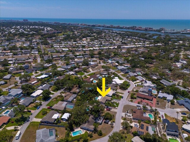 aerial overview of property's location with a large body of water and nearby suburban area