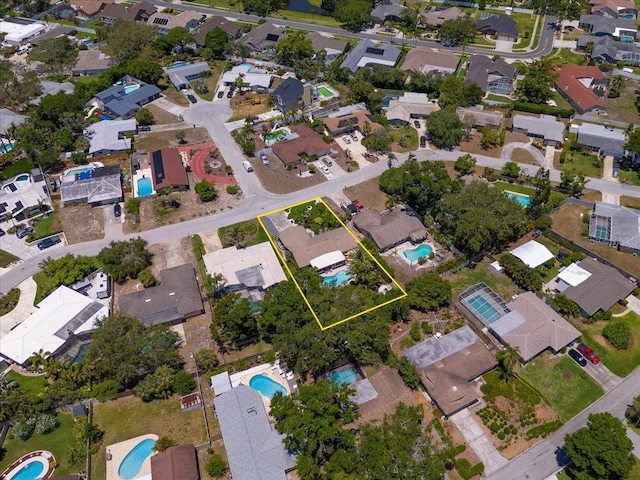 aerial perspective of suburban area with a pool and property parcel outlined