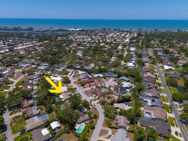aerial view of property's location featuring a large body of water and nearby suburban area