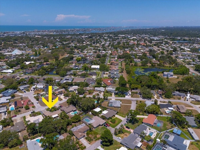 view of property location with a large body of water and nearby suburban area