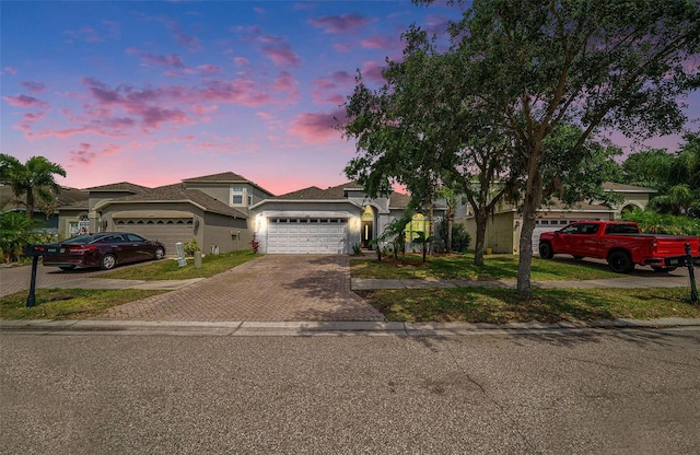 8407 Hunters Fork Loop, Ruskin, FL 33573 - view of front of home featuring decorative driveway, stucco siding, and a garage