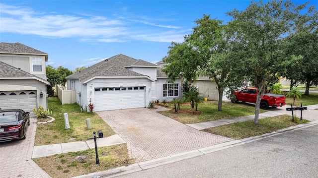 8407 Hunters Fork Loop, Ruskin, FL 33573 - view of front of home with an attached garage, decorative driveway, and a front yard