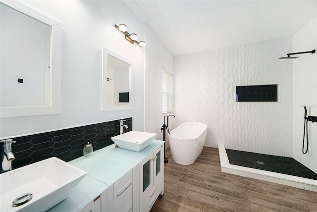 8407 Hunters Fork Loop, Ruskin, FL 33573 - full bath featuring walk in shower, a sink, a freestanding bath, wood finished floors, and backsplash