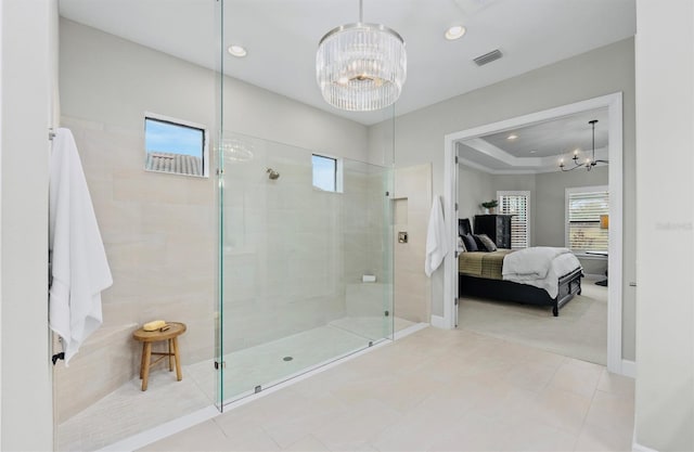 ensuite bathroom with visible vents, baseboards, an inviting chandelier, ensuite bathroom, and tiled shower