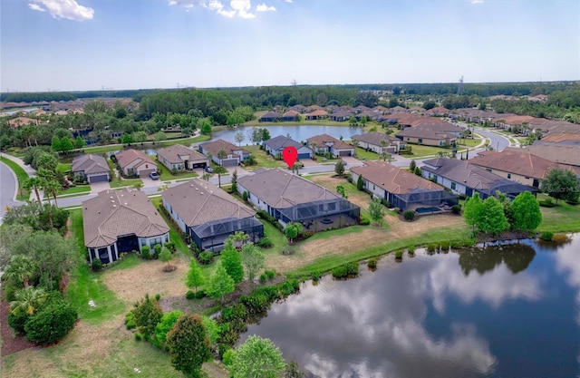 drone / aerial view with a residential view and a water view