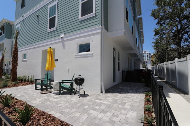 back of property with fence and stucco siding