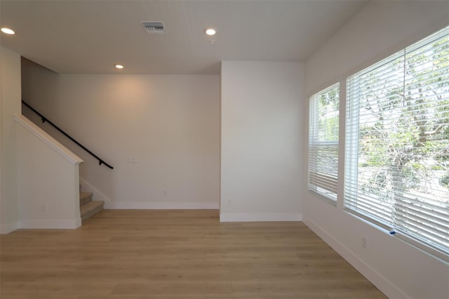 interior space with recessed lighting, baseboards, light wood finished floors, and visible vents
