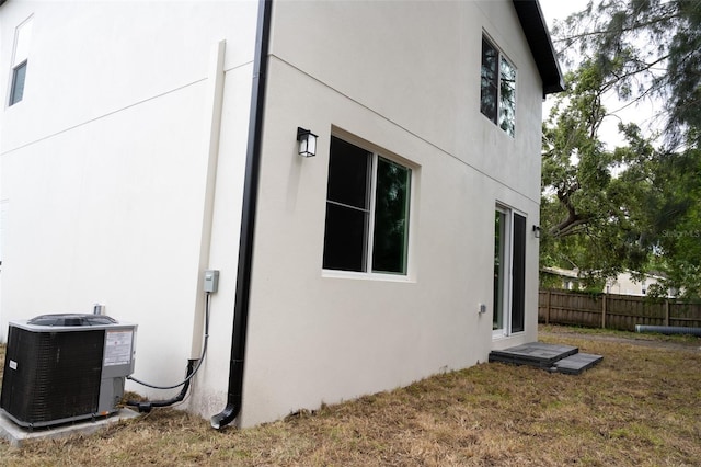 12484 Cross St, Largo, FL 33773 - view of side of property featuring stucco siding and central AC unit