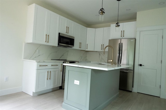 12484 Cross St, Largo, FL 33773 - kitchen featuring appliances with stainless steel finishes, decorative backsplash, light countertops, a sink, and white cabinetry