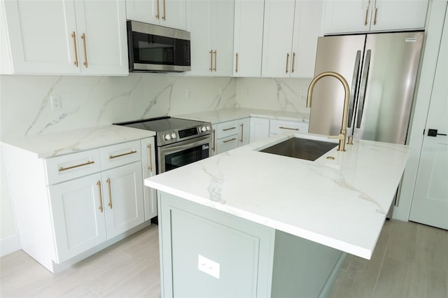 12484 Cross St, Largo, FL 33773 - kitchen featuring stainless steel appliances, a sink, light stone countertops, and decorative backsplash