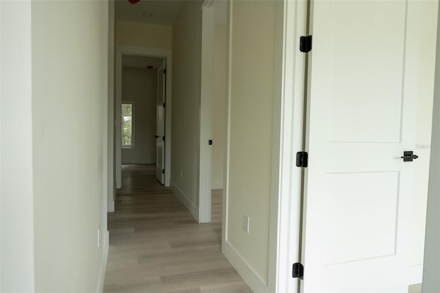 12484 Cross St, Largo, FL 33773 - hallway with baseboards and light wood-type flooring