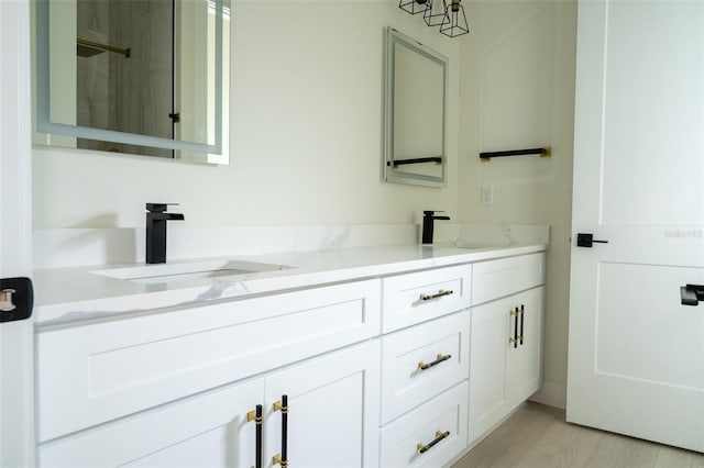 12484 Cross St, Largo, FL 33773 - full bathroom featuring double vanity, a shower, and wood finished floors