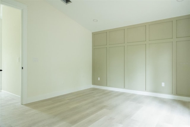 12484 Cross St, Largo, FL 33773 - unfurnished bedroom featuring light wood-style flooring, a decorative wall, baseboards, and a closet