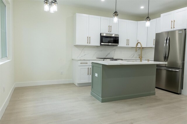12484 Cross St, Largo, FL 33773 - kitchen with stainless steel appliances, light countertops, backsplash, light wood-type flooring, and recessed lighting