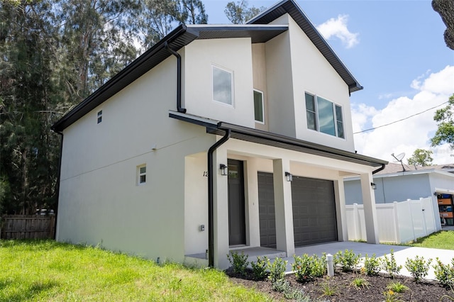 12484 Cross St, Largo, FL 33773 - view of side of home featuring stucco siding, a garage, and driveway
