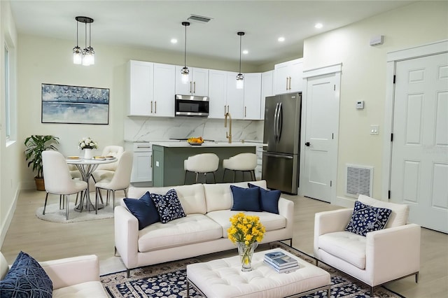 12484 Cross St, Largo, FL 33773 - living area with light wood-style floors and recessed lighting