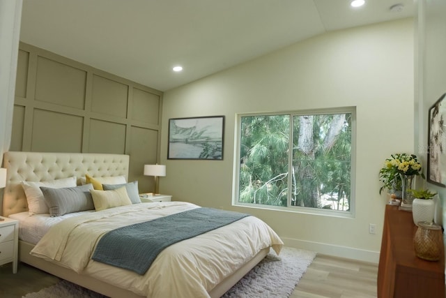 12484 Cross St, Largo, FL 33773 - bedroom with vaulted ceiling, light wood-type flooring, recessed lighting, and a decorative wall