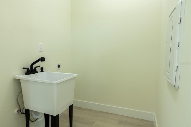 12484 Cross St, Largo, FL 33773 - laundry room featuring baseboards and light wood finished floors