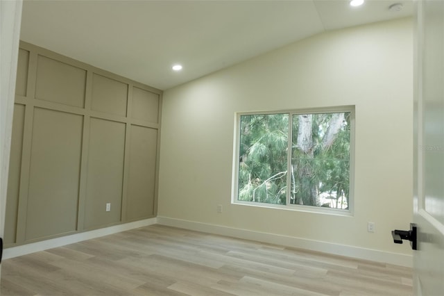 12484 Cross St, Largo, FL 33773 - unfurnished bedroom with vaulted ceiling, recessed lighting, and light wood-type flooring