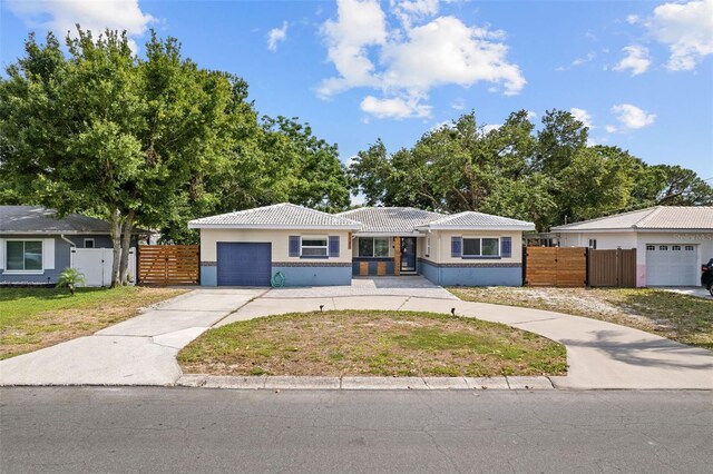 5826 20th Ave S, Gulfport, FL 33707 - single story home featuring a front lawn, fence, a tile roof, and concrete driveway