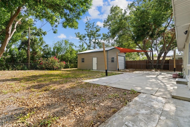 5826 20th Ave S, Gulfport, FL 33707 - view of yard with an outdoor structure, a patio, a fenced backyard, and a detached garage