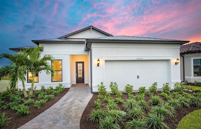 view of front of home with an attached garage and stucco siding