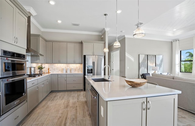 kitchen with visible vents, open floor plan, gray cabinets, light wood-style flooring, and stainless steel appliances