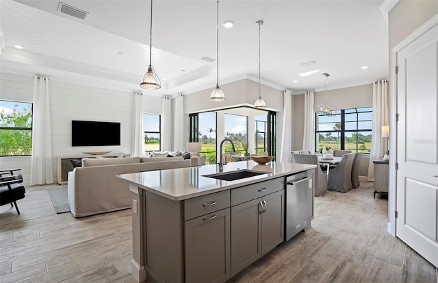 kitchen with gray cabinets, visible vents, stainless steel dishwasher, a sink, and open floor plan