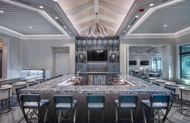 interior space featuring an inviting chandelier, crown molding, visible vents, lofted ceiling, and hanging light fixtures