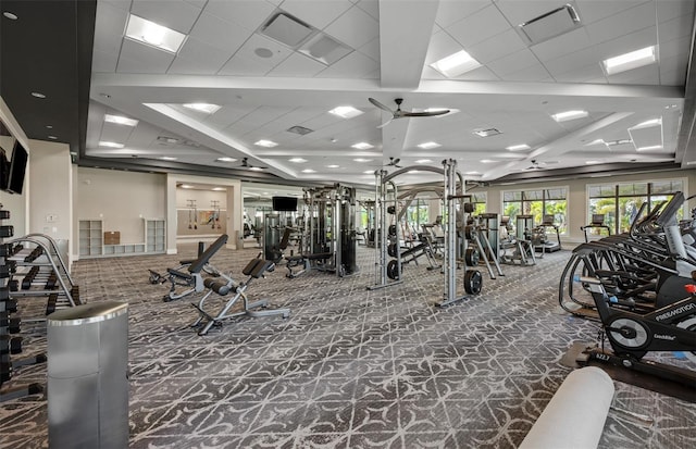 workout area featuring carpet floors, a ceiling fan, and visible vents