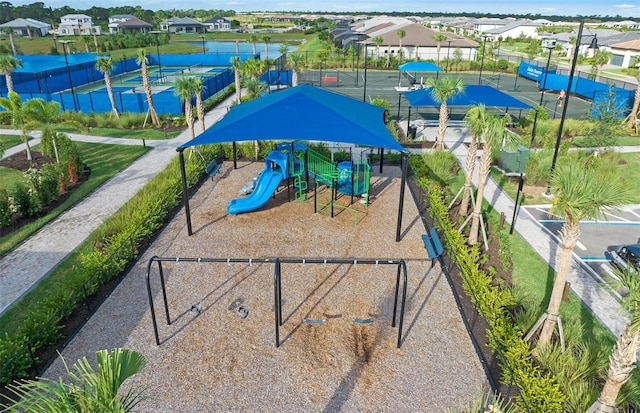 surrounding community with a water view, a residential view, and playground community