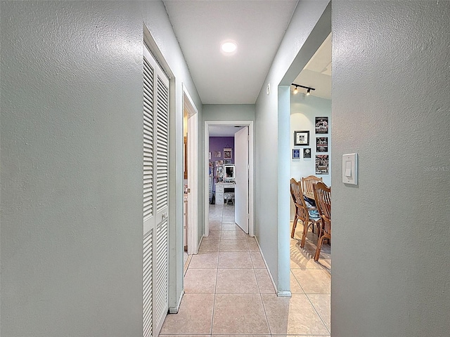 7237 Bramblewood Dr, Port Richey, FL 34668 - corridor with light tile patterned floors, baseboards, and a textured wall
