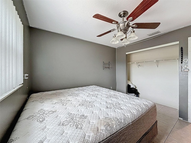 7237 Bramblewood Dr, Port Richey, FL 34668 - bedroom with a ceiling fan, visible vents, tile patterned flooring, and a closet