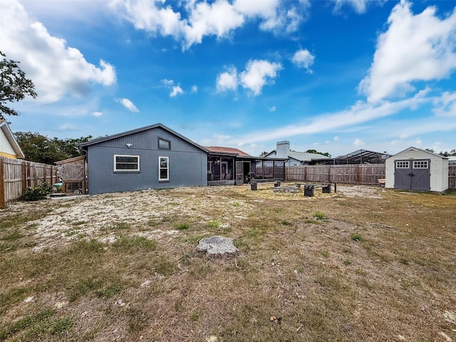 7237 Bramblewood Dr, Port Richey, FL 34668 - view of yard featuring a sunroom, an outdoor structure, a fenced backyard, and a storage shed
