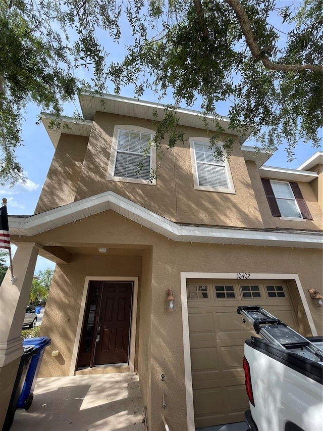 view of front of house with an attached garage and stucco siding