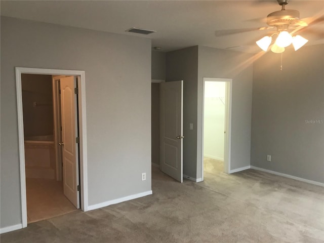 unfurnished bedroom featuring visible vents, a ceiling fan, carpet, and baseboards