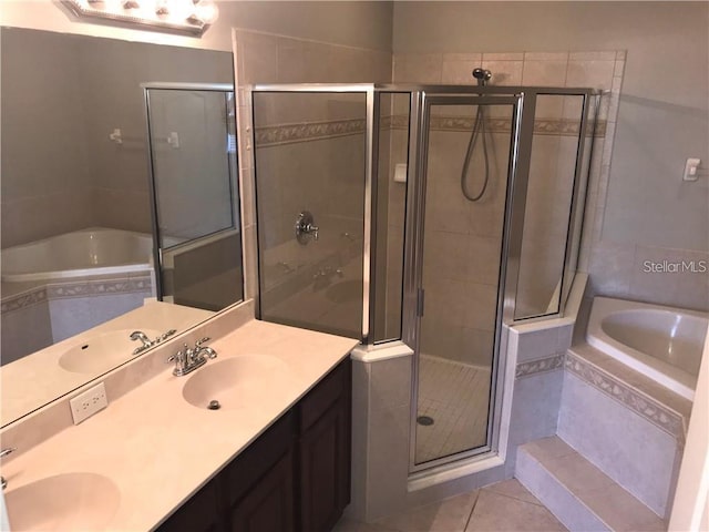 bathroom with a sink, tile patterned floors, and a stall shower