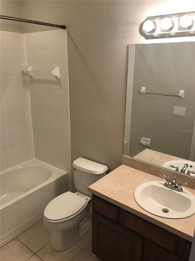 full bath featuring tile patterned flooring, bathing tub / shower combination, toilet, and vanity
