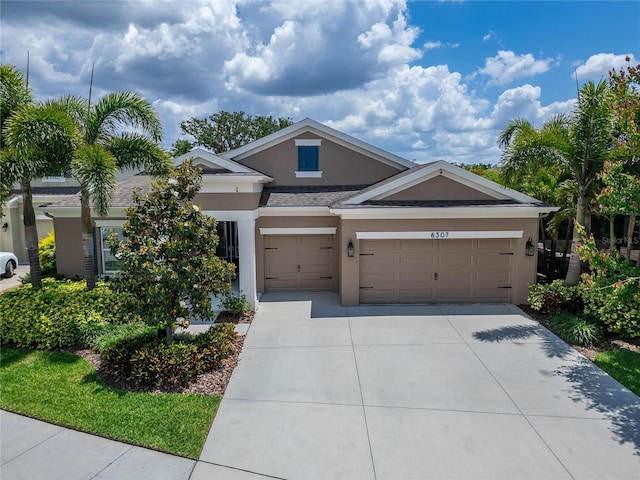 6507 Maiden Sea Dr, Apollo Beach, FL 33572 - view of front facade with an attached garage, stucco siding, and driveway