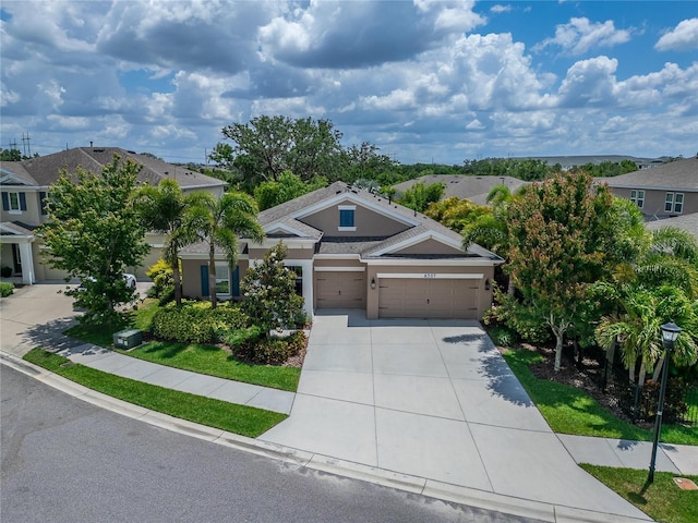 6507 Maiden Sea Dr, Apollo Beach, FL 33572 - view of front of home with an attached garage, driveway, a residential view, and stucco siding