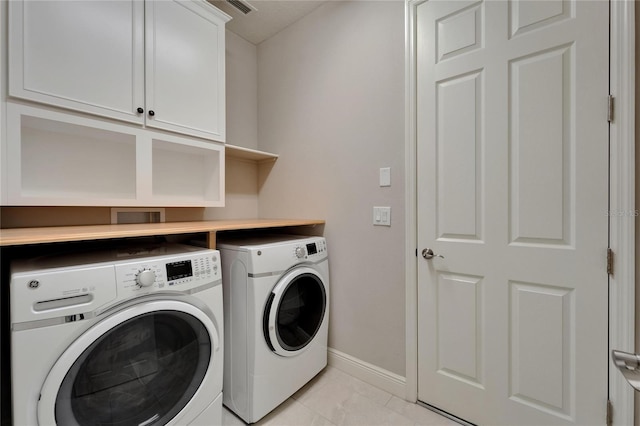 6507 Maiden Sea Dr, Apollo Beach, FL 33572 - laundry room with cabinet space, separate washer and dryer, baseboards, and light tile patterned flooring