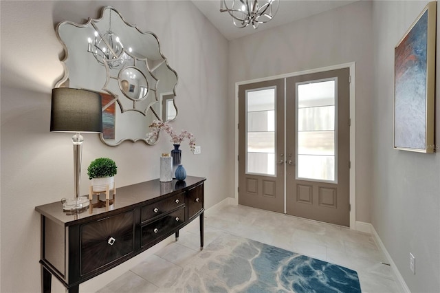 6507 Maiden Sea Dr, Apollo Beach, FL 33572 - foyer entrance featuring tile patterned floors, baseboards, french doors, and a chandelier