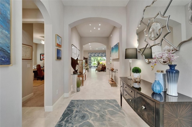 6507 Maiden Sea Dr, Apollo Beach, FL 33572 - corridor featuring arched walkways, baseboards, recessed lighting, and light tile patterned floors
